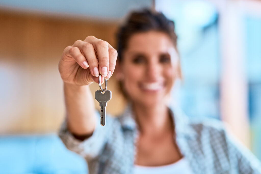 Woman holding keys to her husbands chastity cage